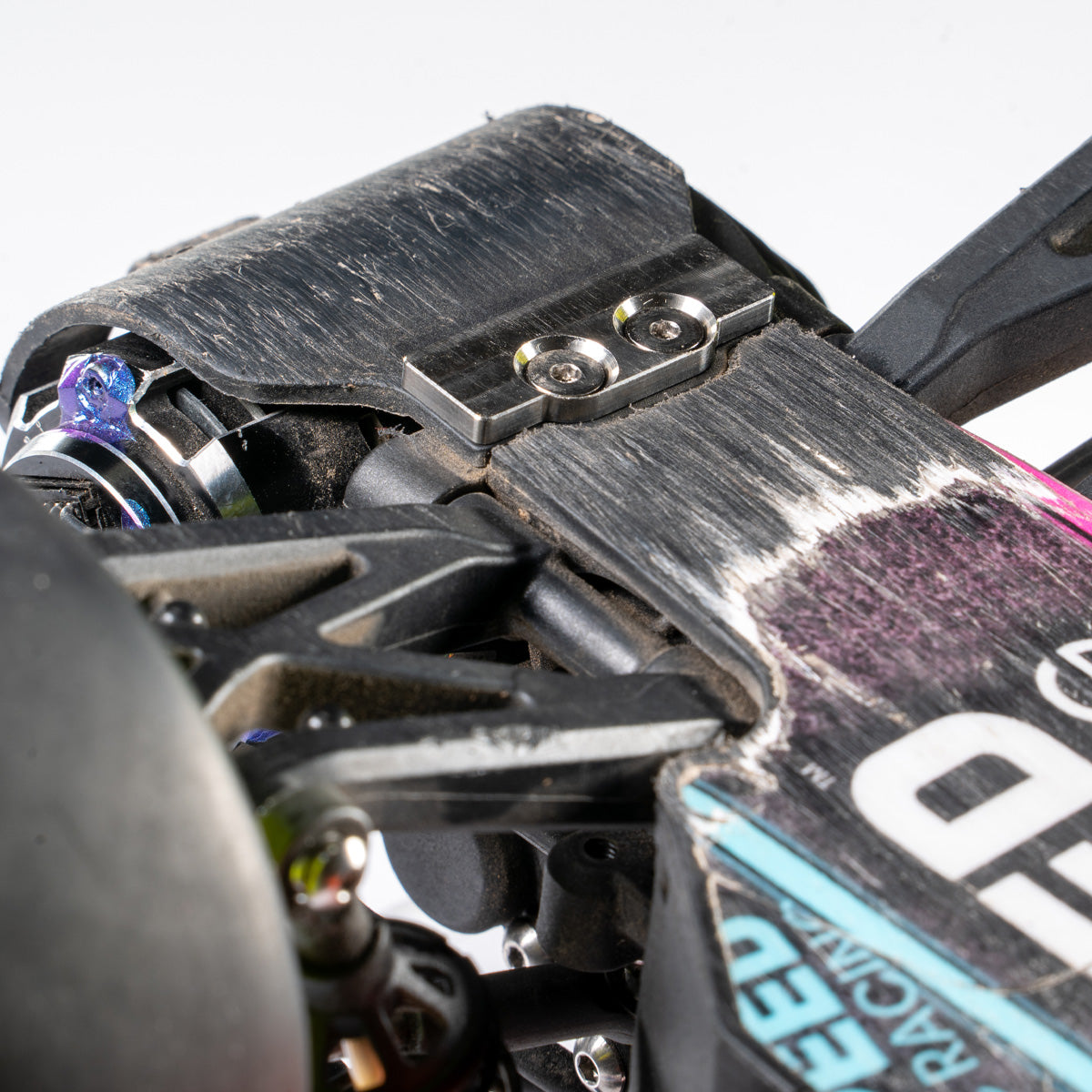 Titanium machined plate mounted to chassis of Associated RB10