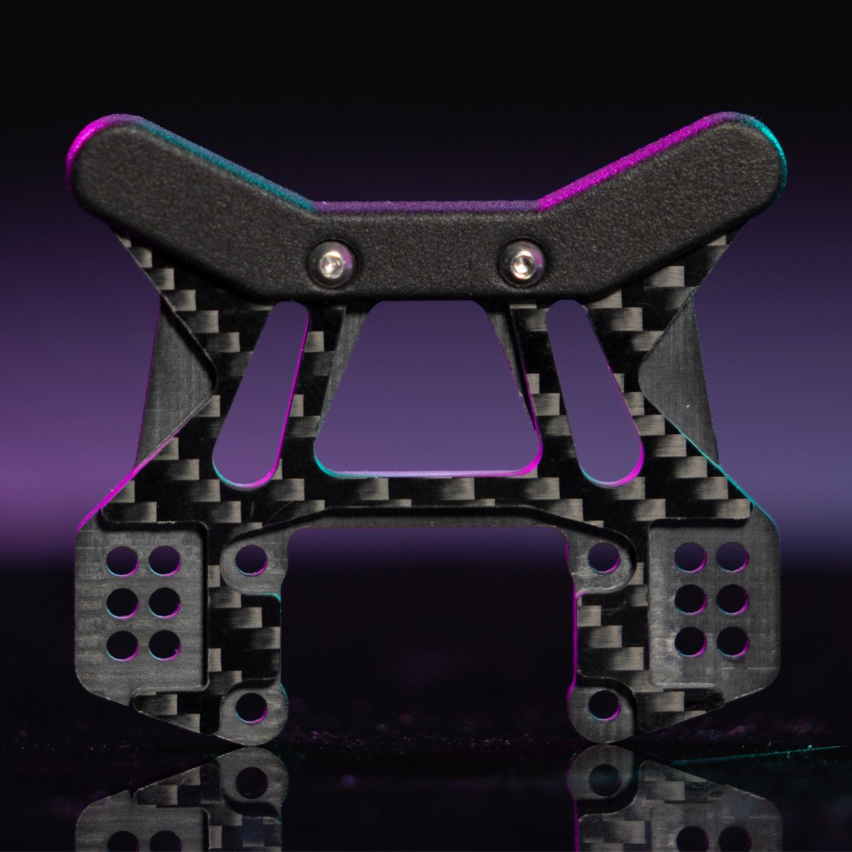 Assembled associated RB10 carbon fiber front shock tower alone against purple background