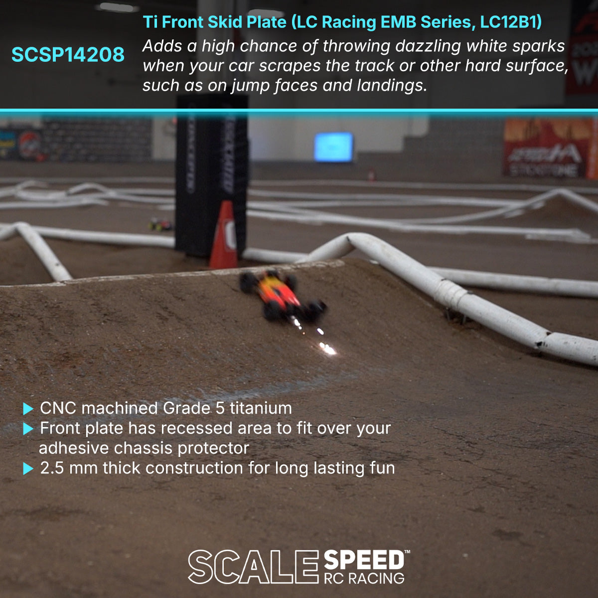 LC Racing EMB-1 throwing sparks on jump face of indoor clay track